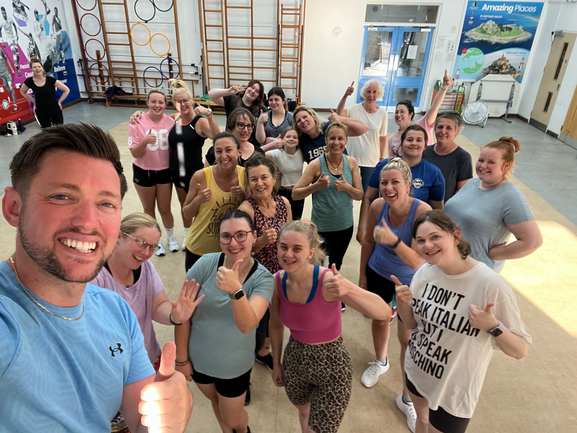 Jason Pook with a full class of smiling participants in Cornwall